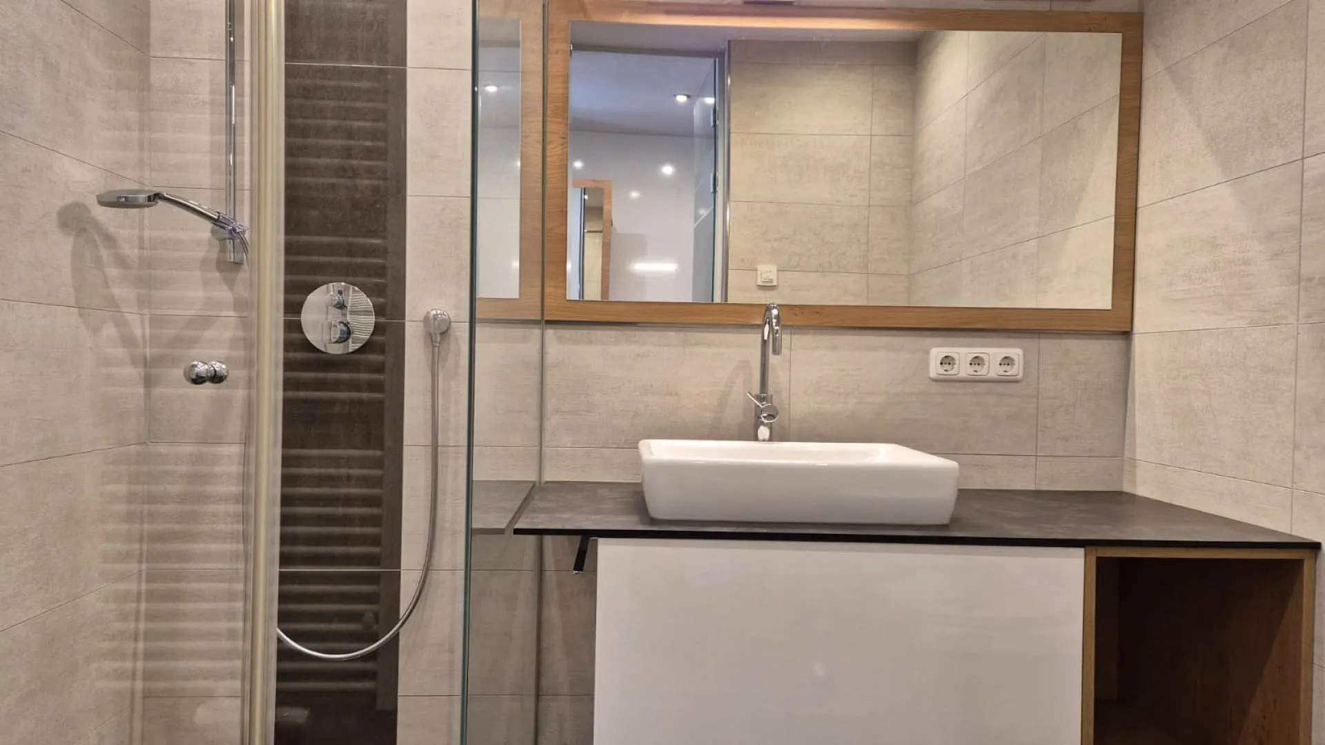 Modern bathroom with shower, sink, and mirror