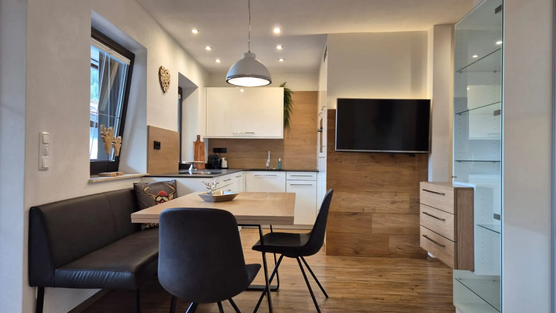 Modern dining room with wooden elements and seating